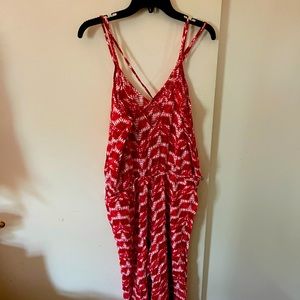 Sleeveless, jumpsuit with belt, pink w/darker pink undertones. Tie dye effect.